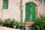 House with green door and potted plants Provence France